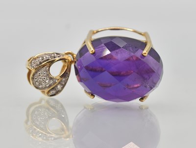 Lot 1383 - A 9ct gold mounted oval all over cut amethyst...