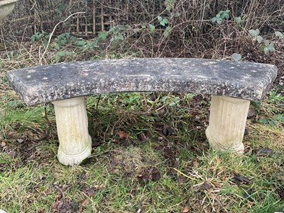 Lot 1244 - A reconstituted stone curved garden bench,...