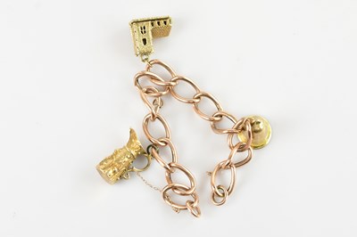 Lot 1544 - A 9ct rose gold charm bracelet marked ‘9ct’,...