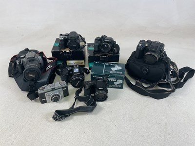 Lot 373 - A quantity of cameras, to include Canon,...