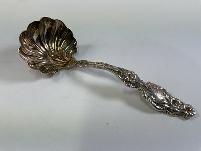 Lot 579 - A sterling silver ladle, with detailed floral...