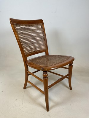 Lot 725 - A fruit wood nursing chair with cane back and...