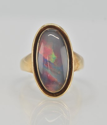 Lot 1206 - A 9ct yellow gold opal ring, set with a large...