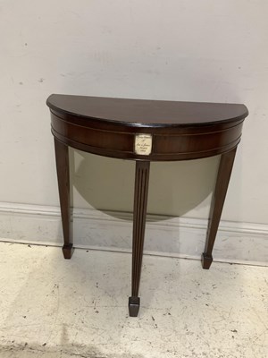 Lot 1204 - An early 20th century mahogany demi-lune table,...