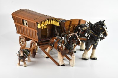 Lot 215 - Three ceramic Shire horse figures pulling...