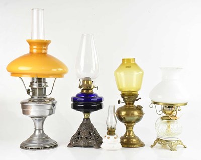Lot 1310 - A collection of five oil lamps, including...