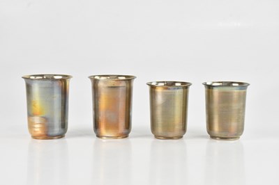 Lot 1521 - Four white metal beakers, unmarked, height of...