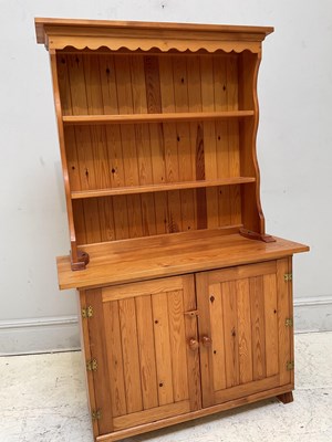 Lot 1181 - A modern pine dresser with boarded plate rack...