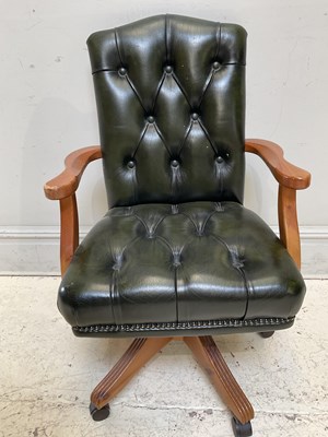 Lot 1183 - A modern green leather office chair.