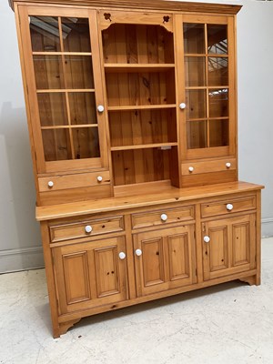 Lot 1137 - A modern pine dresser with two glazed doors...