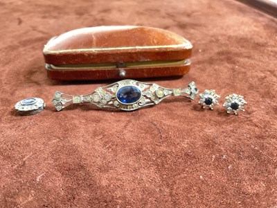 Lot 553 - A silver paste bar brooch with central blue...