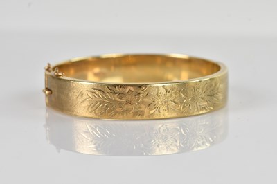 Lot 109 - A 9ct yellow gold hinged snap bangle, with...