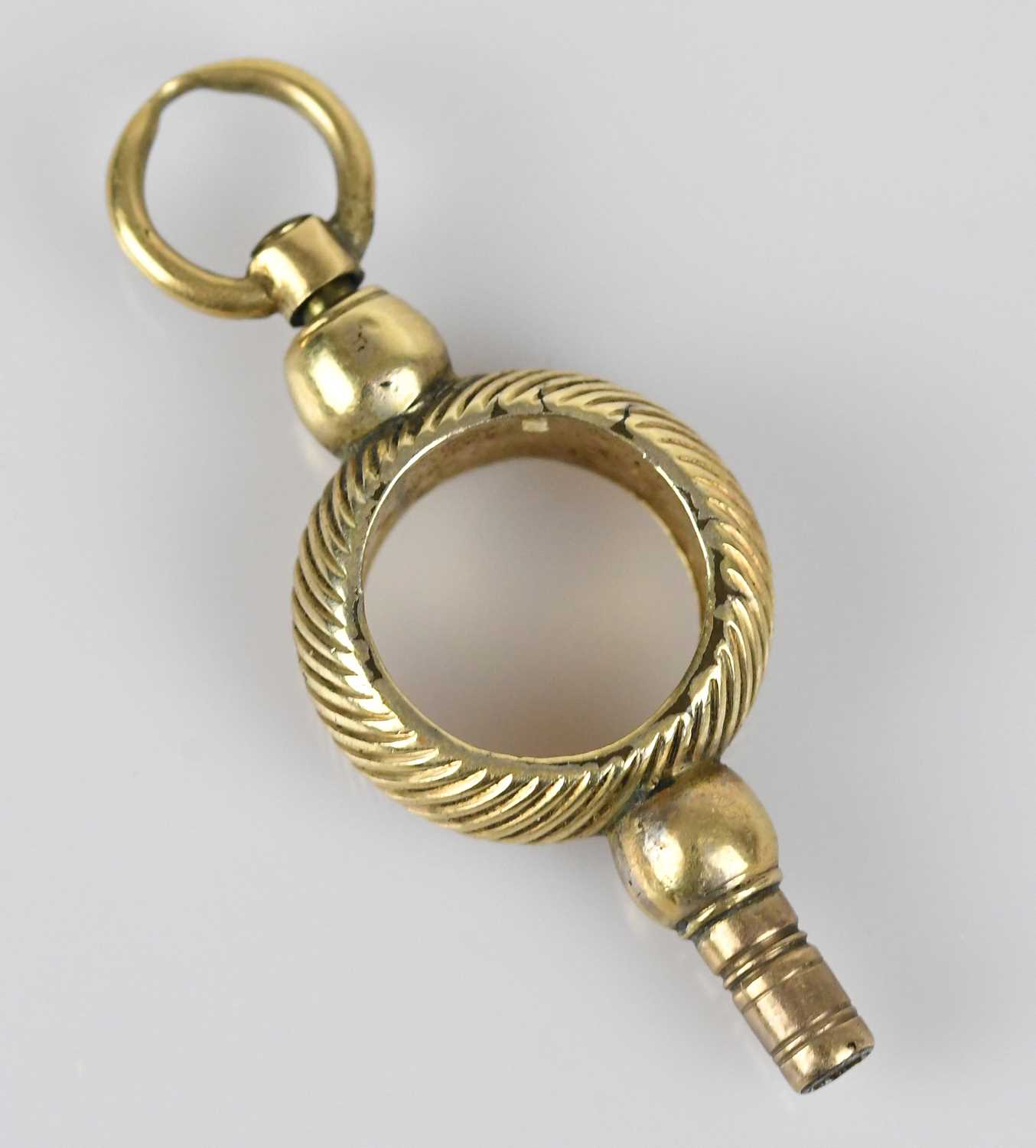 Lot 31 - A 19th century yellow metal pocket watch key,...