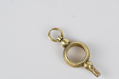 Lot 31 - A 19th century yellow metal pocket watch key,...