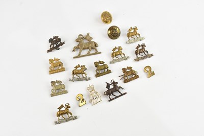 Lot 581 - A small collection of military cap badges and...