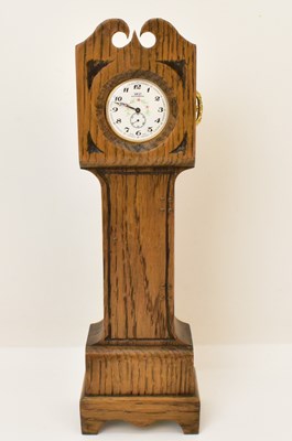 Lot 121 - An oak pocket watch stand in the form of a...