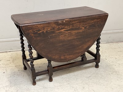 Lot 1203 - A 1920s oak drop-leaf table, height 73cm,...