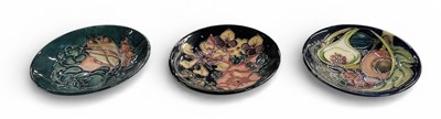 Lot 602 - MOORCROFT; three art pottery circular pin...