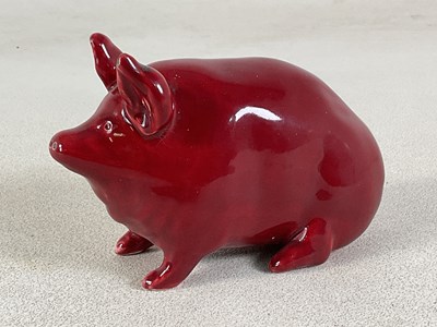 Lot 292 - WEMYSS WARE; a red glazed model of a pig,...