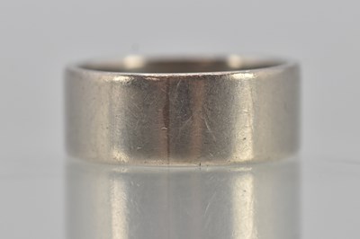 Lot 1209 - A 950 grade platinum band ring, width 7mm,...