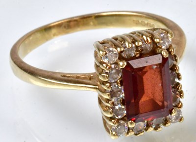 Lot 776 - A 9ct yellow gold ring set with a red stone...