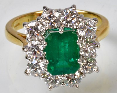 Lot 767 - An 18ct yellow gold ring set with an emerald...