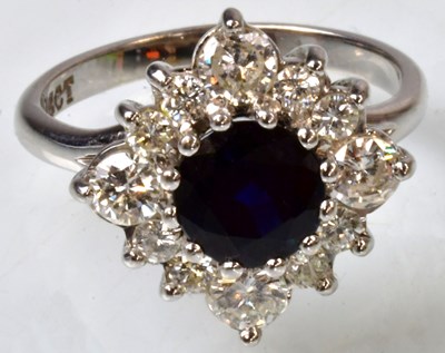 Lot 766 - An 18ct white gold cluster ring set with a...