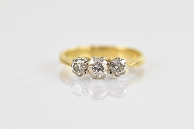 Lot 606 - An 18ct yellow gold diamond three stone ring...