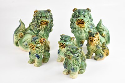 Lot 1374 - Six graduated ceramic models of ShiShi dogs,...