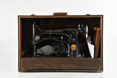 Lot 1238 - A cased Singer sewing machine.
