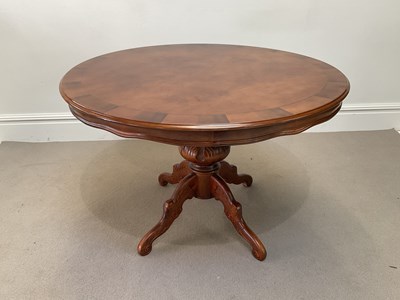 Lot 1067 - A reproduction circular top dining table,...