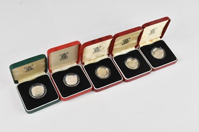 Lot 635 - A group of four 1983 silver proof £1 coins,...