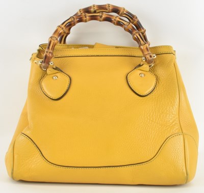 Lot 509 - GUCCI; a lady's mustard yellow leather 'Diana'...