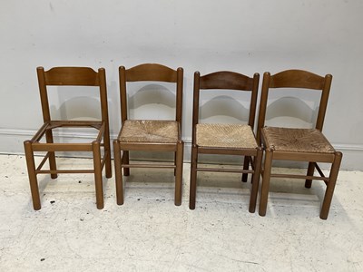 Lot 1102 - A set four mid century chairs with rush seats.