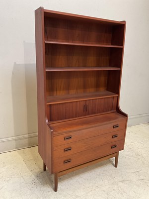 Lot 1087 - A mid century teak bookcase with two sliding...