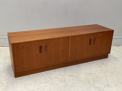 Lot 1086 - G PLAN; a low teak sideboard with four...