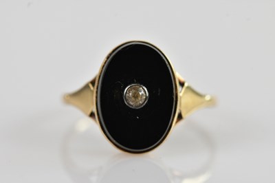 Lot 552 - An Art Deco yellow metal onyx set dress ring,...