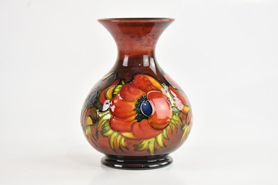 Lot 24 - WALTER MOORCROFT; a baluster shaped vase with...