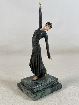 Lot 137 - A bronzed and simulated ivory Art Deco figure...