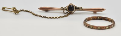 Lot 1159 - A 9ct rose gold bar brooch, with bezel set cut...