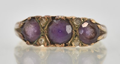 Lot 1300 - A 9ct rose gold three stone amethyst set ring,...