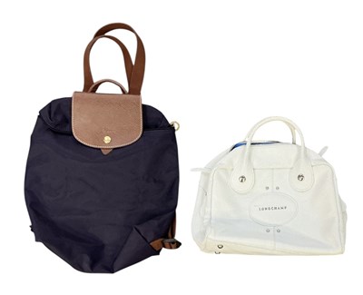 Lot 482 - LONGCHAMP; a brown leather mounted navy blue...