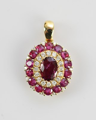 Lot 442 - A 14k yellow gold pendant set with an oval cut...