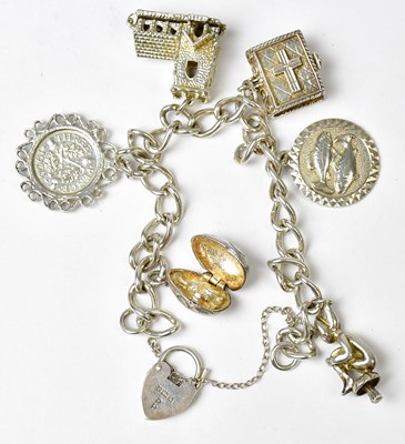 Lot 805 - A hallmarked silver charm bracelet with...