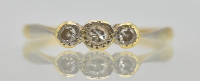 Lot 1264 - An 18ct yellow gold ring set with three small...