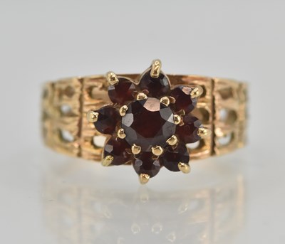 Lot 1265 - A 1970s 9ct yellow gold garnet cluster ring,...