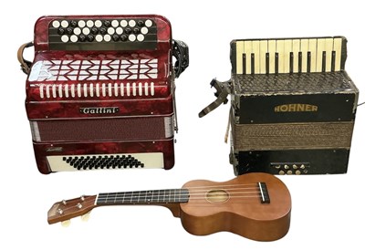 Lot 384 - GALLINI; a cased vintage accordion, 35 x 39cm,...