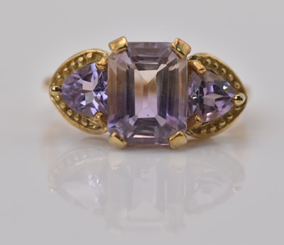 Lot 468 - A 9ct yellow gold three stone pale amethyst...
