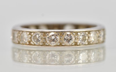 Lot 1320 - An 18ct white gold diamond full eternity ring,...