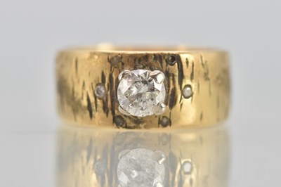 Lot 1198 - An 18ct yellow gold diamond set band, set with...